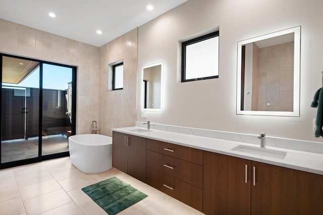 bathroom with tile patterned flooring, vanity, separate shower and tub, and tile walls