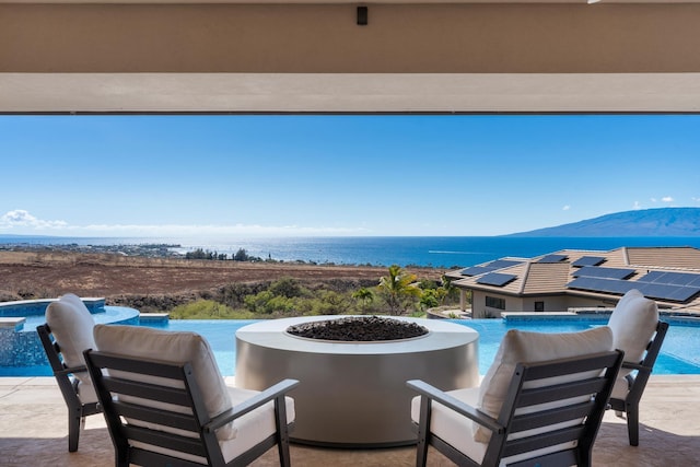 view of patio featuring a fire pit and a water view