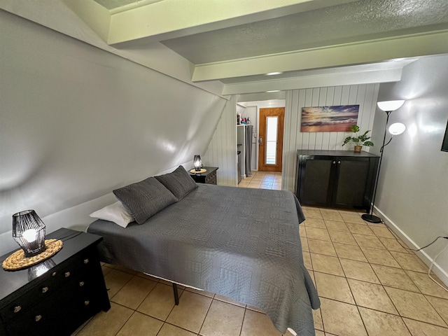 bedroom featuring light tile patterned floors and beamed ceiling