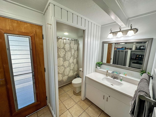 bathroom with vanity, tile patterned floors, wooden walls, and toilet