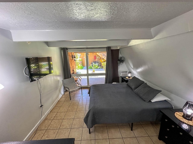 bedroom featuring light tile patterned floors, a textured ceiling, and access to outside