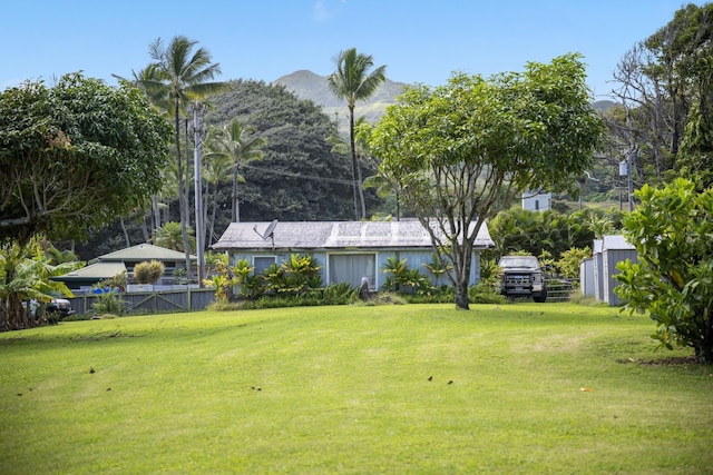 view of yard with fence and a mountain view