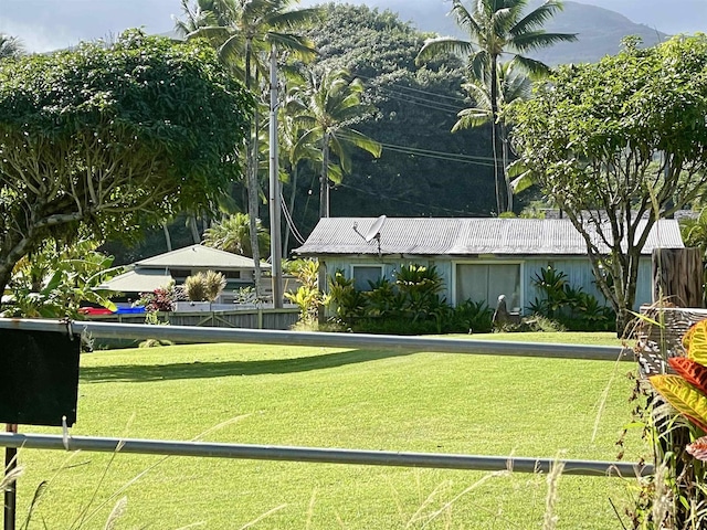 surrounding community featuring a lawn and a mountain view