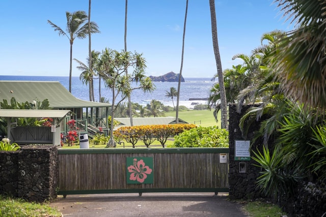 view of gate featuring a water and mountain view