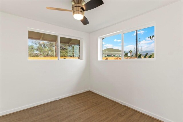 spare room featuring hardwood / wood-style floors and ceiling fan