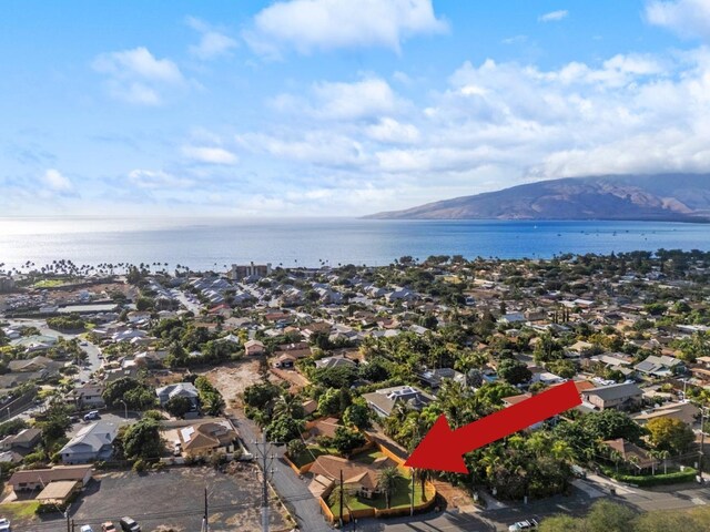 birds eye view of property with a water and mountain view