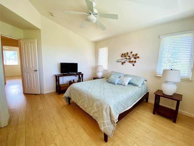 bedroom with multiple windows, ceiling fan, and light hardwood / wood-style floors