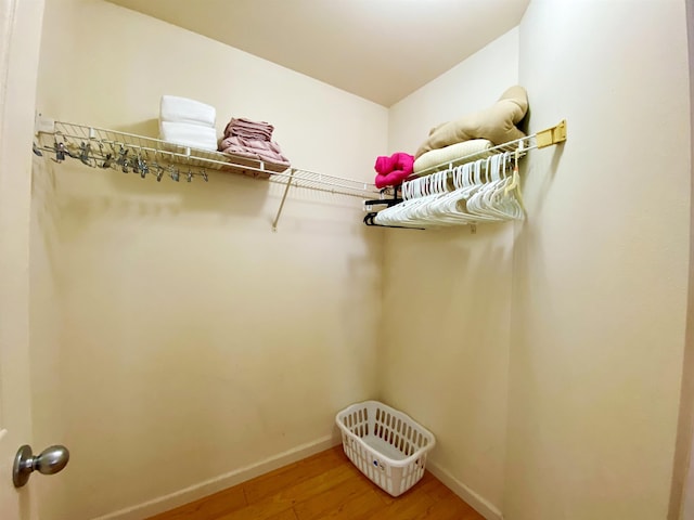 walk in closet with hardwood / wood-style floors