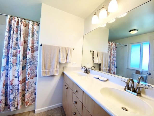 bathroom with tile patterned flooring, walk in shower, and vanity