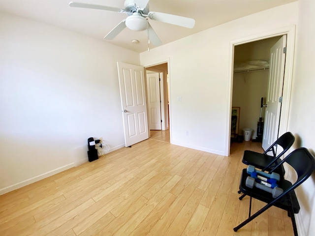 living area featuring ceiling fan and light hardwood / wood-style floors