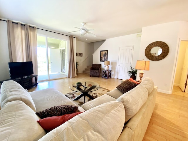 living room featuring ceiling fan and wood-type flooring