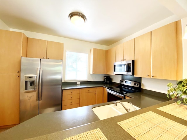 kitchen with stainless steel appliances, sink, and light brown cabinets