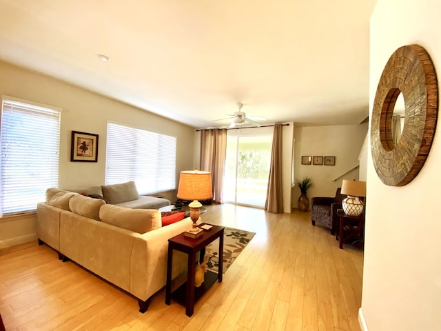 living room featuring light hardwood / wood-style flooring and ceiling fan