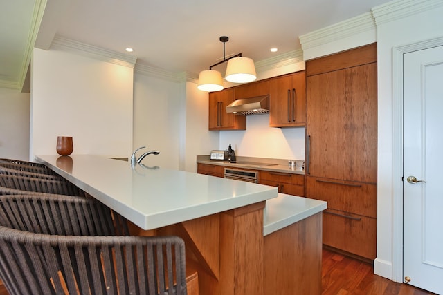 1 Ritz Carlton Dr Unit 1626, Lahaina, HI 96761 - kitchen featuring wall chimney range hood, stainless steel oven, brown cabinets, crown molding, and a breakfast bar area