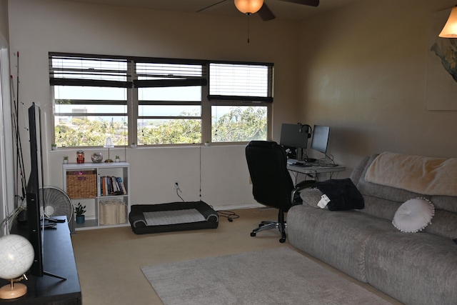carpeted home office featuring a ceiling fan and plenty of natural light