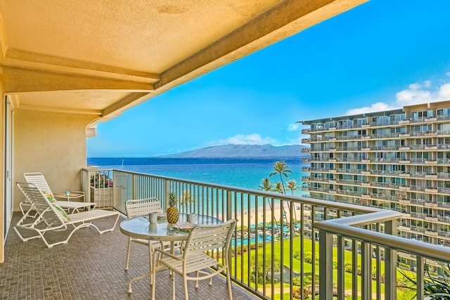 balcony with a water and mountain view