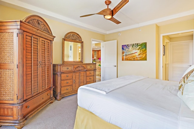 bedroom with ceiling fan, a closet, and light carpet