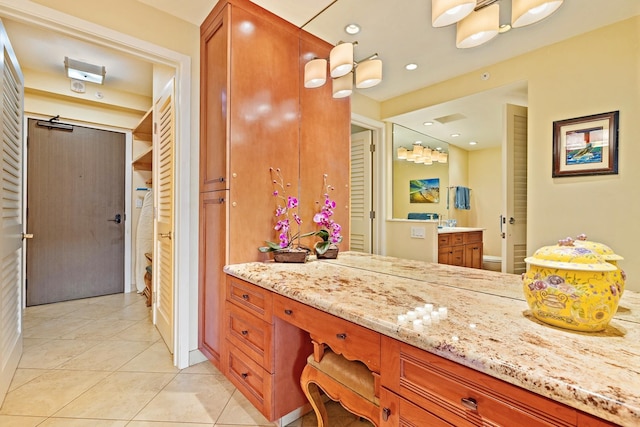 bathroom with tile patterned flooring, vanity, and toilet