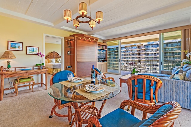 dining area with carpet flooring, an inviting chandelier, and beamed ceiling