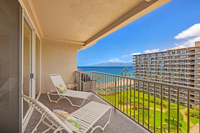 balcony featuring a water and mountain view