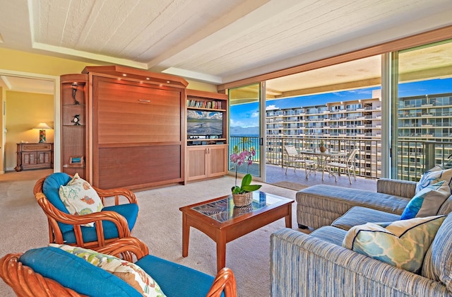 carpeted living room with beamed ceiling and wooden ceiling