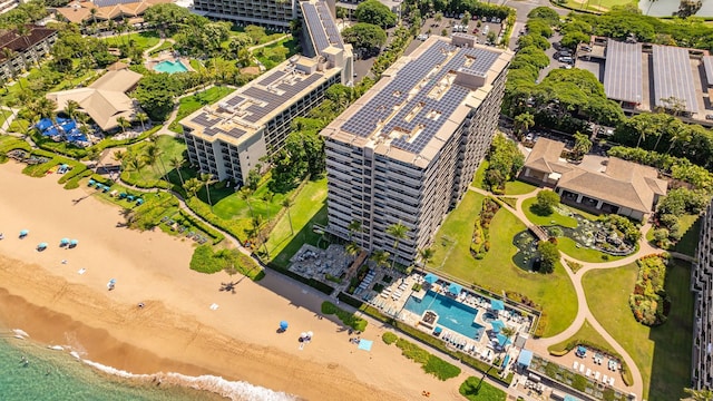 birds eye view of property featuring a water view and a beach view