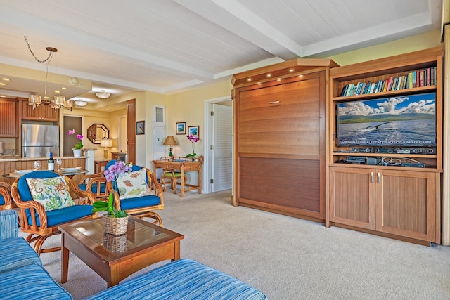 carpeted living room featuring beam ceiling and an inviting chandelier