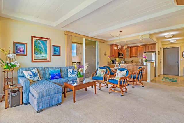 living room with light carpet, a notable chandelier, and beam ceiling