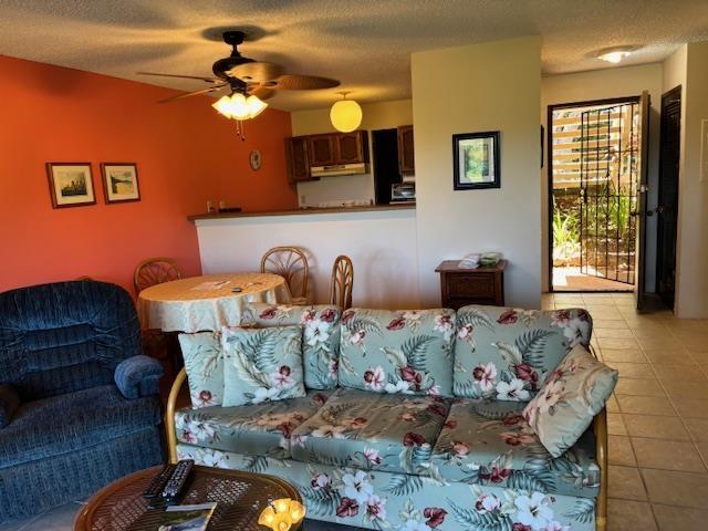 50 Kepuhi Pl Unit 159, Maunaloa, HI 96770 - tiled living room with a ceiling fan and a textured ceiling