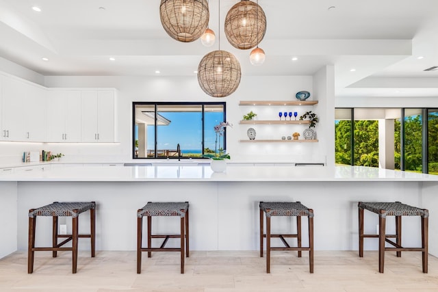 kitchen featuring white cabinetry and a breakfast bar