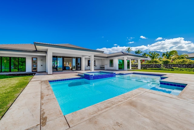 view of swimming pool featuring an in ground hot tub and a patio