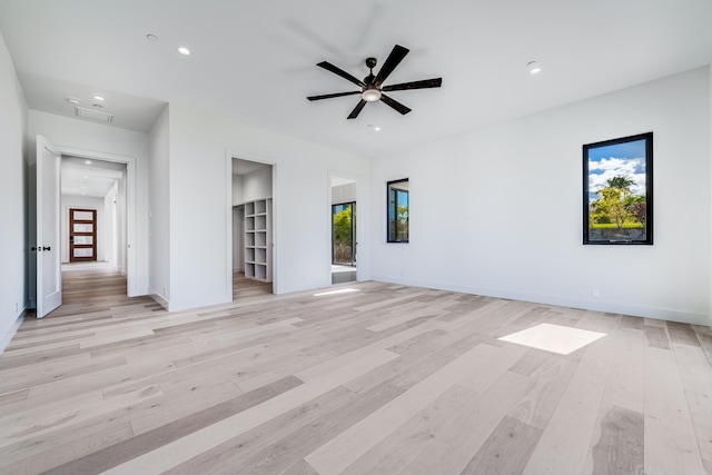 unfurnished living room with light wood-type flooring and ceiling fan