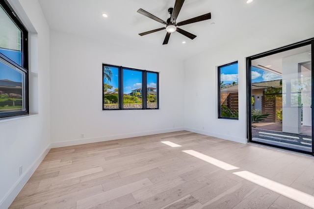 empty room with ceiling fan and light hardwood / wood-style floors