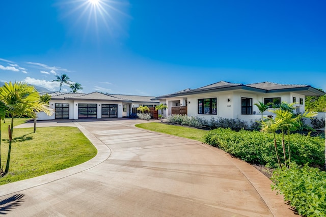 view of front facade with a garage and a front lawn