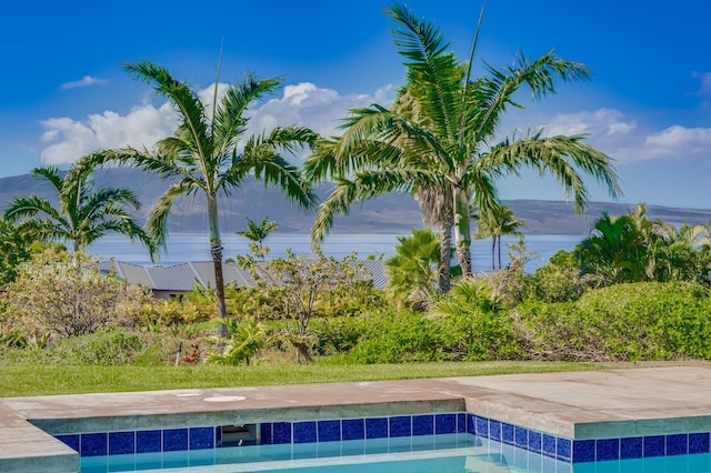 view of pool featuring a water view