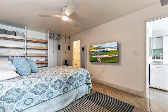 bedroom with ensuite bathroom and a ceiling fan
