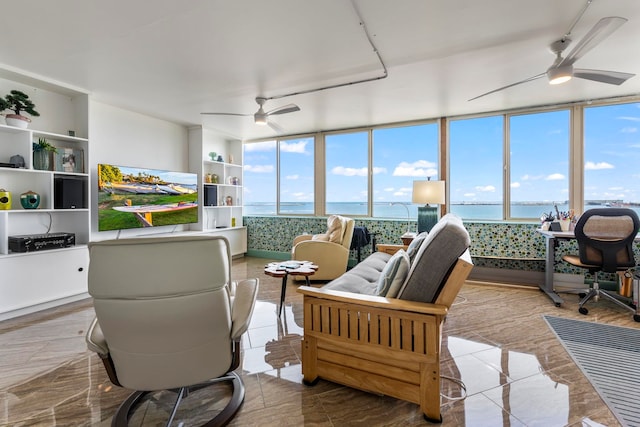 sunroom / solarium with a water view