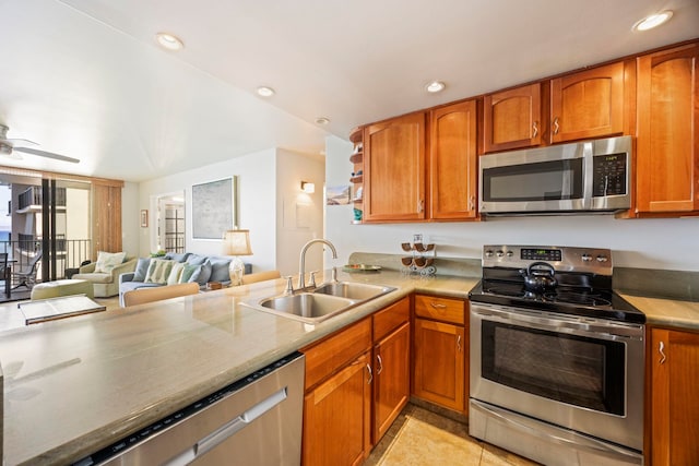 kitchen featuring kitchen peninsula, ceiling fan, sink, and appliances with stainless steel finishes