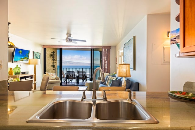 kitchen featuring ceiling fan and sink