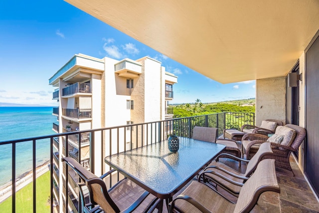 balcony featuring a view of the beach and a water view