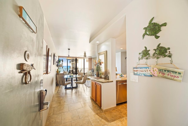 interior space featuring dishwasher, light tile patterned flooring, and hanging light fixtures