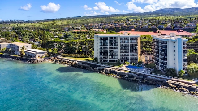 drone / aerial view featuring a water and mountain view