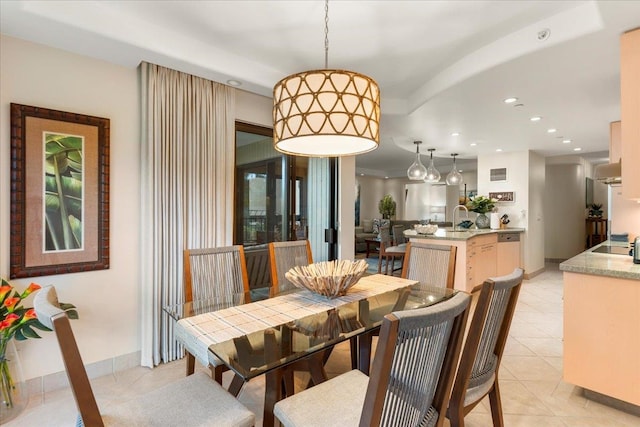 dining room featuring sink and light tile patterned floors