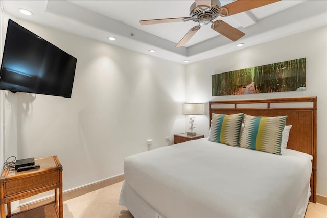 bedroom featuring ceiling fan and a tray ceiling