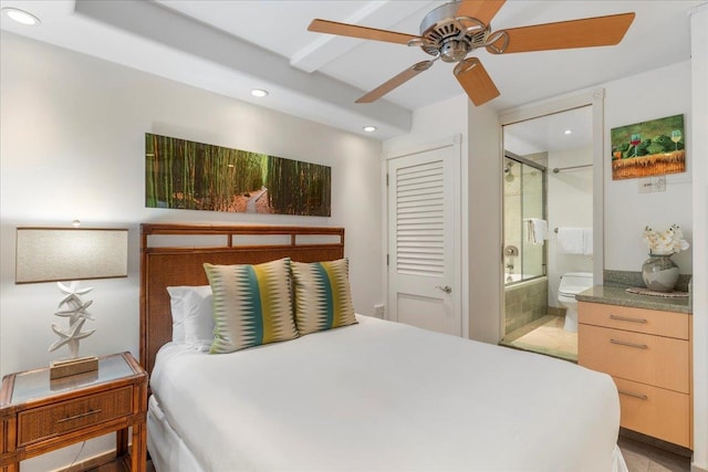 tiled bedroom with ensuite bathroom, ceiling fan, and a closet