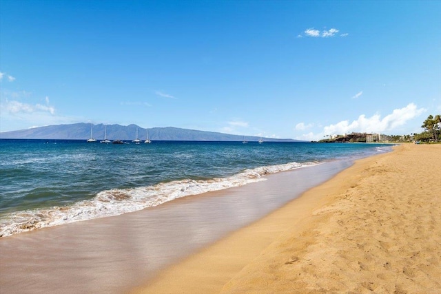 property view of water featuring a mountain view and a beach view