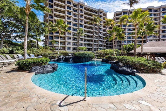 view of swimming pool with pool water feature