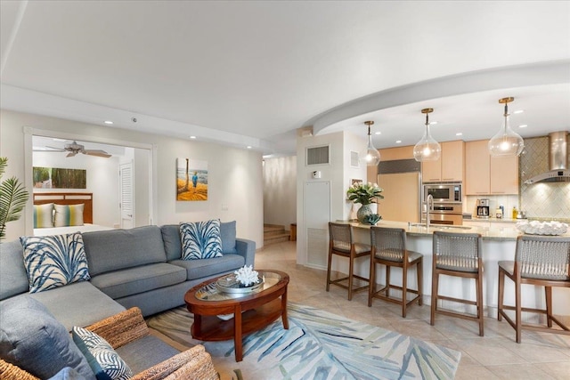 living room featuring light tile patterned flooring and ceiling fan