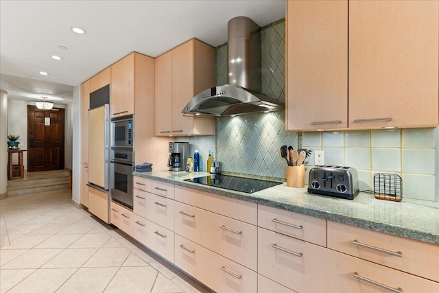 kitchen with light brown cabinets, wall chimney exhaust hood, light tile patterned flooring, stainless steel oven, and black electric stovetop