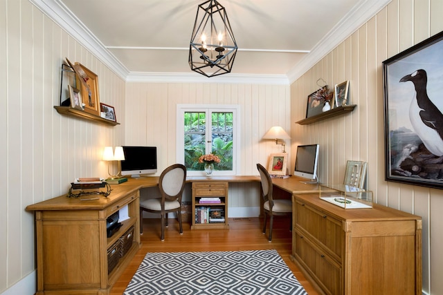 home office featuring crown molding, light hardwood / wood-style flooring, wood walls, and a notable chandelier